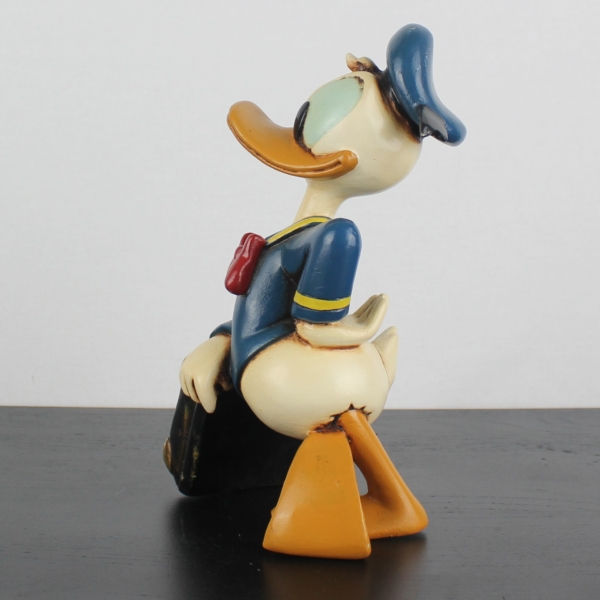 Donald Duck relaxing on his suitcase statue _medium version _left - Donald Duck relaxing on his suitcase statue _medium version _left