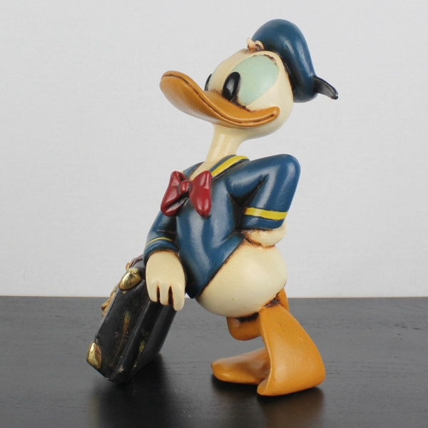 Donald Duck relaxing on his suitcase statue _medium version _left front - Donald Duck relaxing on his suitcase statue _medium version _left front