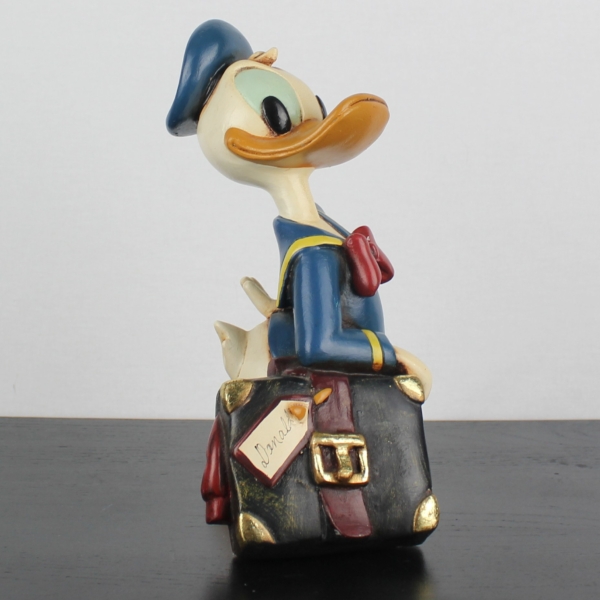 Donald Duck relaxing on his suitcase statue _medium version _right front - Donald Duck relaxing on his suitcase statue _medium version _right front