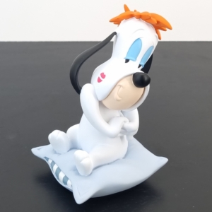 Statue where Droopy is sitting on a blue pillow