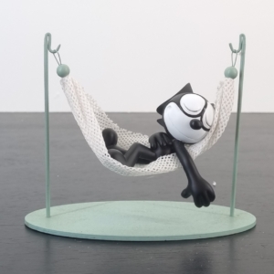 Statue of Felix the Cat sleeping in a hammock