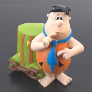 Fred Flintstone money box with green stone-style container