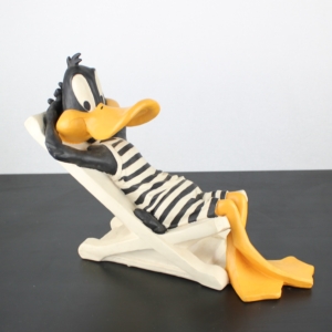 Daffy Duck sunbathing statue by Arden Sculptures in license of Warner Bros.