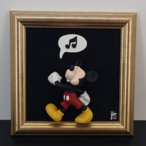 Mickey Mouse whistling wall art in a golden frame