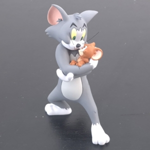 Tom holding Jerry figurine