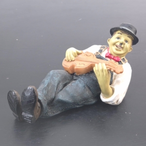 Vintage Laurel and Hardy figurine Oliver Hardy playing violin reclining resin collectible statue