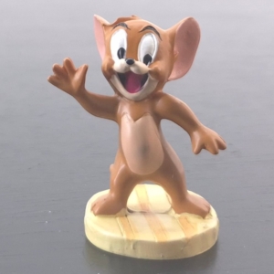 Jerry Mouse figurine waving on a light wood-effect base
